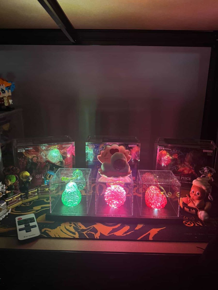 A shelf display of lit fruits